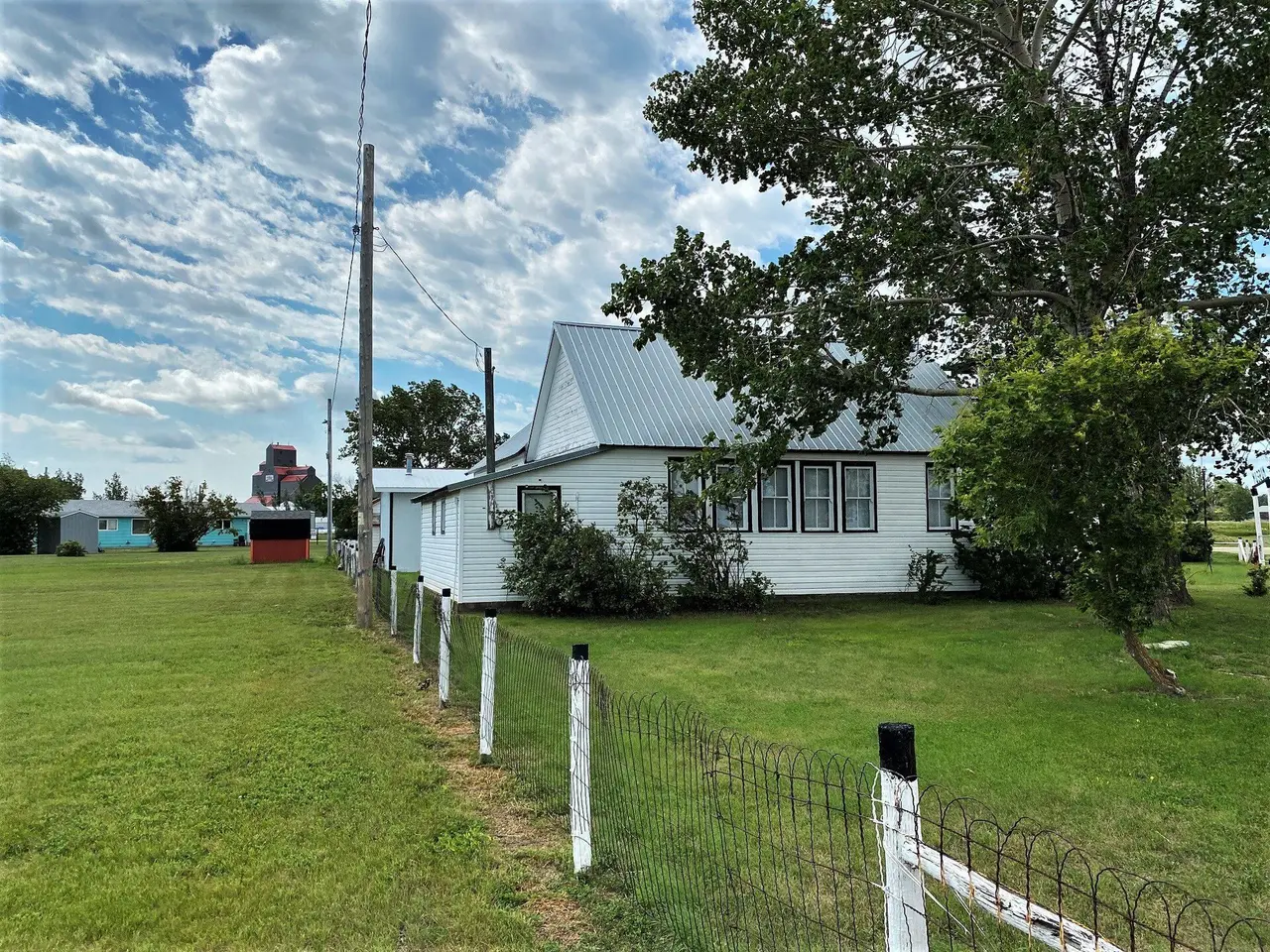 Prairie Pioneer Museum with grain elevator in the distance, 2022
